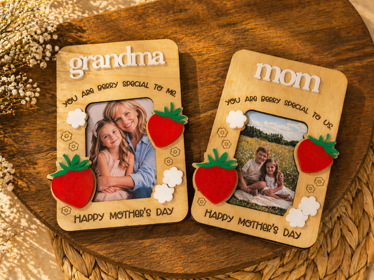 Two wooden photo frames for 'grandma' and 'mom' with family photos and decorative elements on a wooden surface.