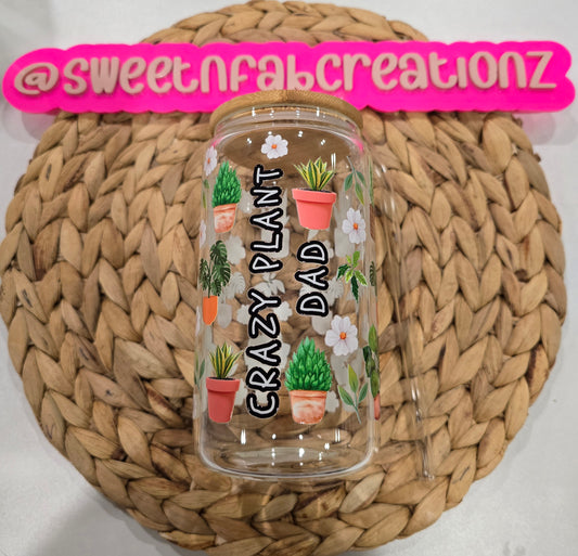 Clear tumbler with plant designs and text on a woven mat, branded with 'sweetnfabcreationz'.